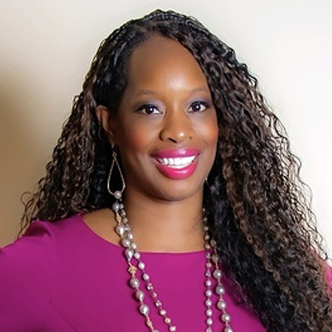 A woman with long hair and wearing a necklace.