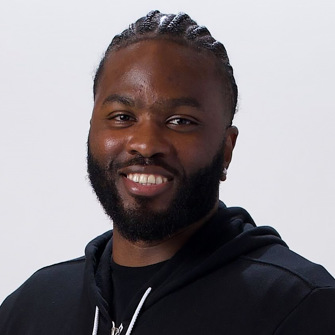 A man with dreadlocks and black hoodie.